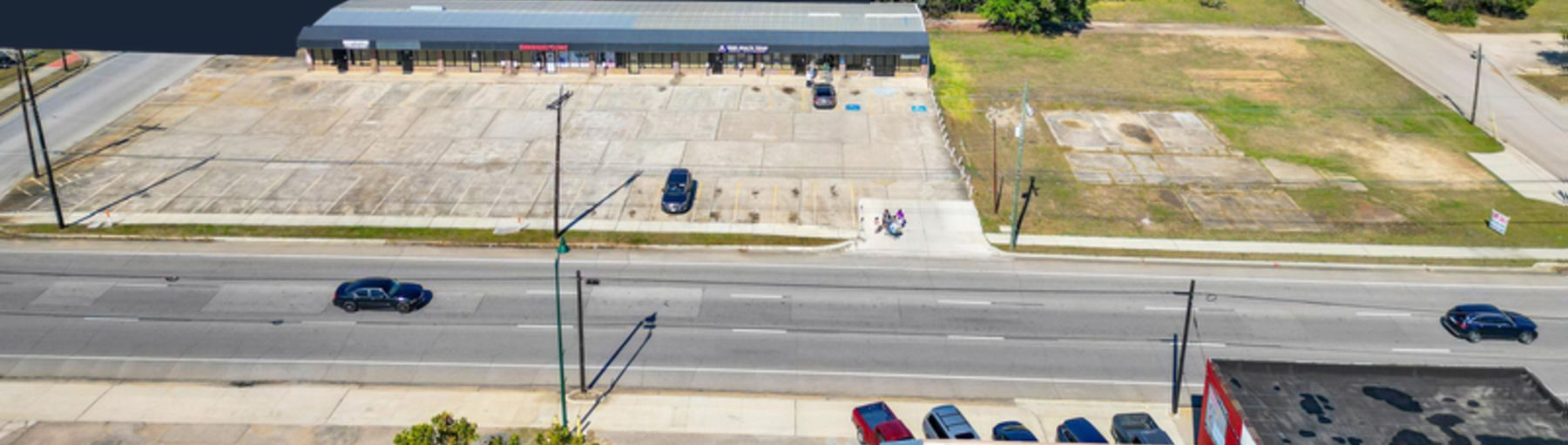 Aerial view of the 310 E Davis St retail center, its parking lot and the Highway 105 Business frontage