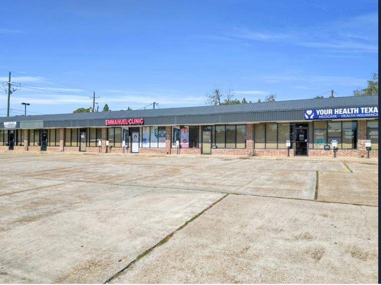 Street-level view of the multi-suite storefront elevation at 310 E Davis St with individual tenant entries