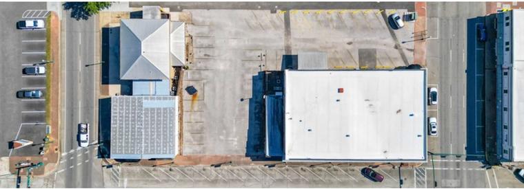 Directly overhead aerial of the full city block showing the multiple structures and surrounding streets
